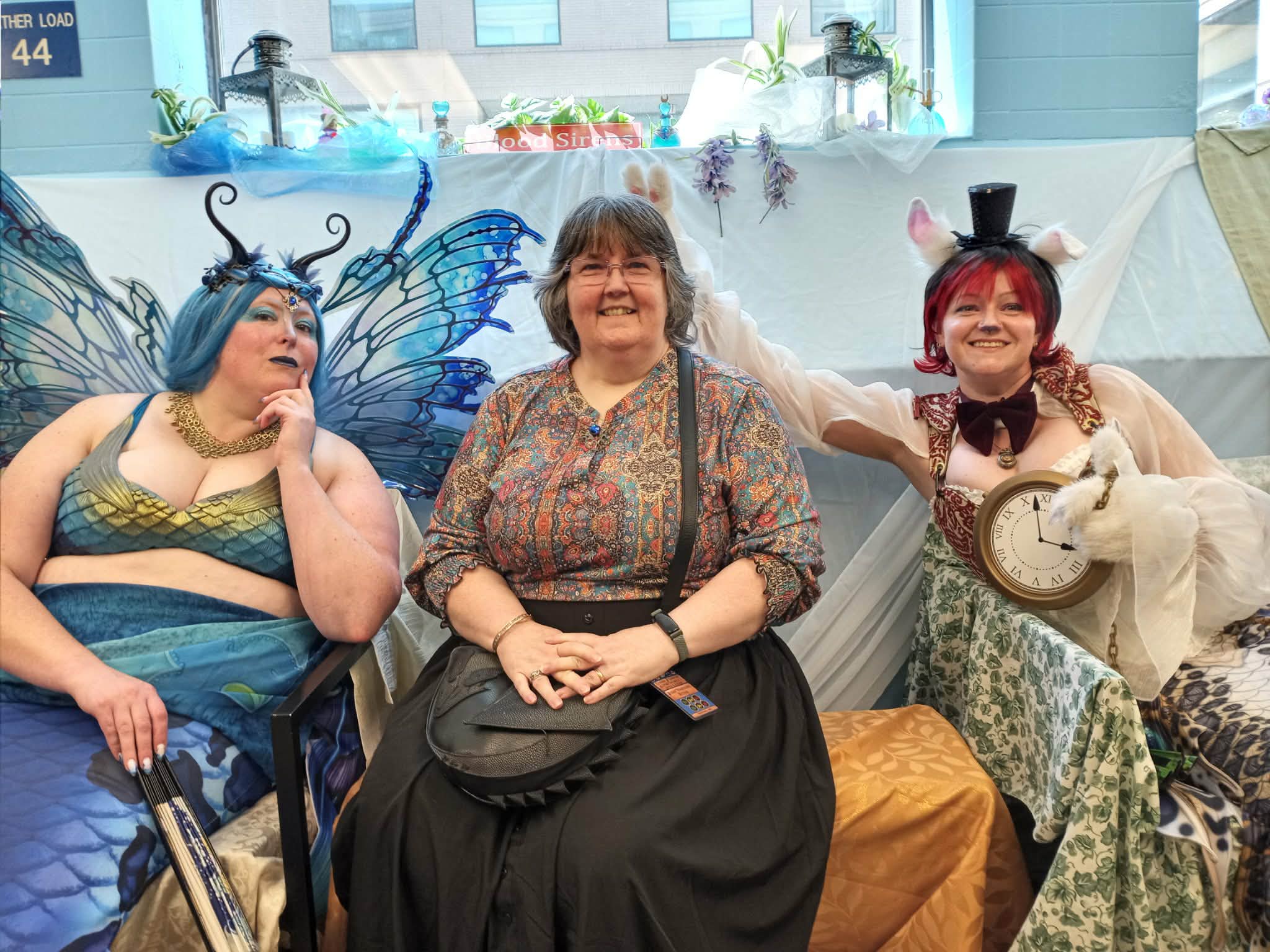 Sue between the queen of mermaids on the left and the rabbit with a clock on the right. Taken at Chicago Steampunk Expo 2026